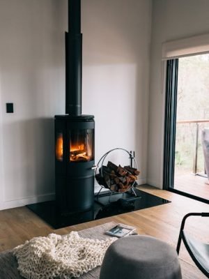 A cozy modern living room with a stylish fireplace and wood accents.